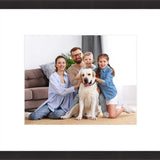Framed family photo with parents, kids, and a dog.