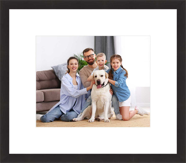 Framed family photo with parents, kids, and a dog.