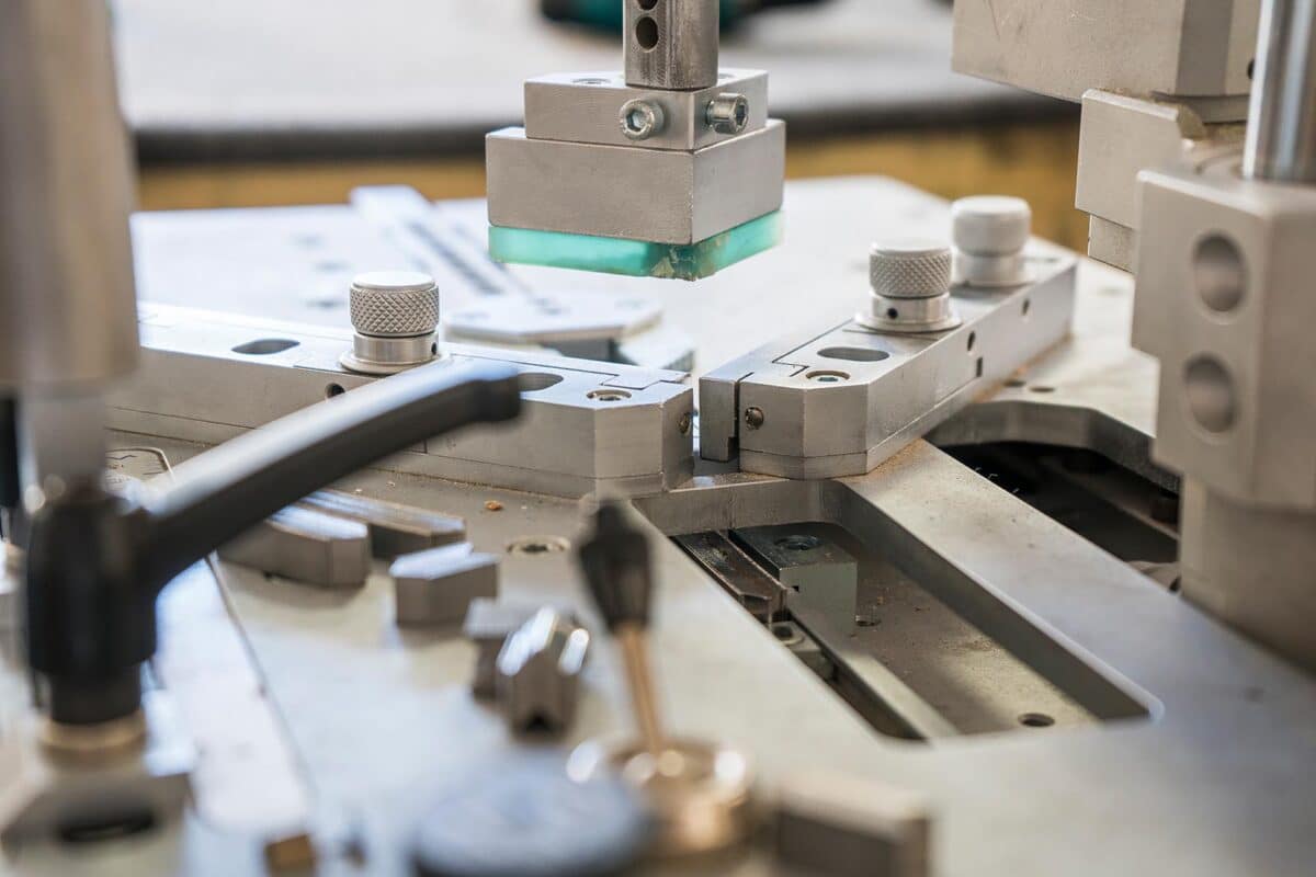 Close-up of an industrial framing machine used for precision corner joins in picture frame assembly.